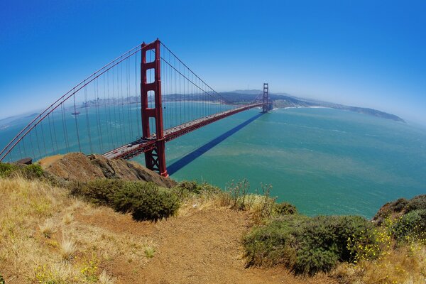 A long bridge over the water. Blue sky