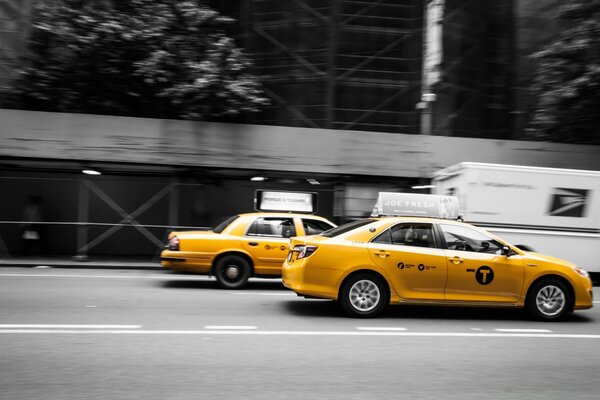 Yellow taxi on city roads