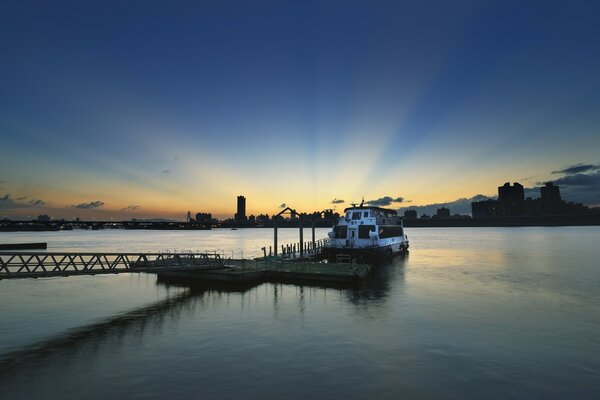 Beautiful sunset over the lake with a ship