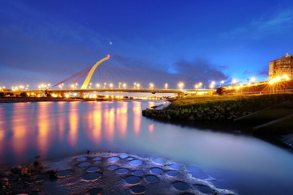 City sunset on the background of the lake at night