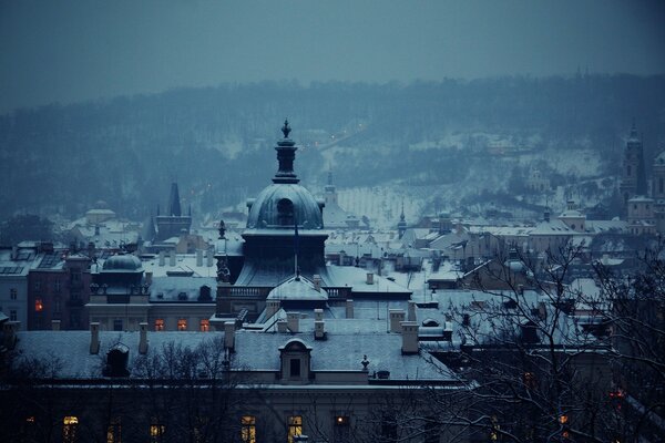 A snow-covered city in the evening twilight