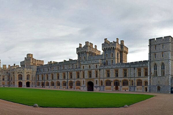 Old-fashioned architecture, a castle with a green lawn