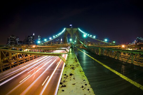 Night bridge with motorway and pedestrian road