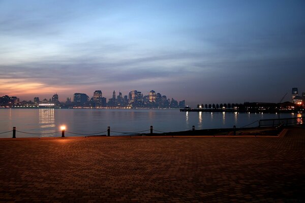 Sea sunset in another city on the background of water