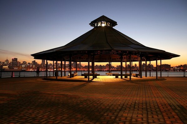 Large gazebo on the embankment late in the evening