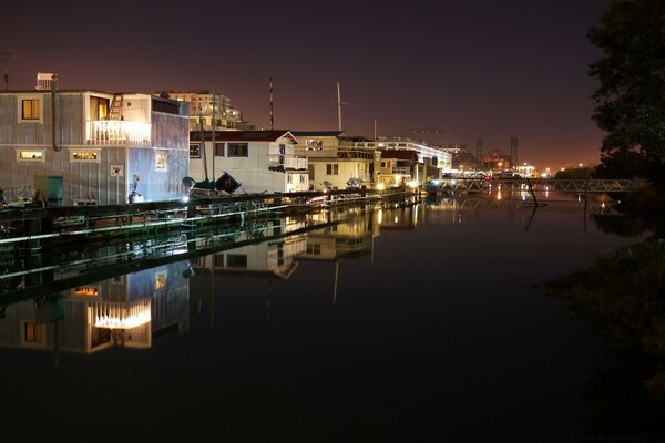 The night city is reflected in the river