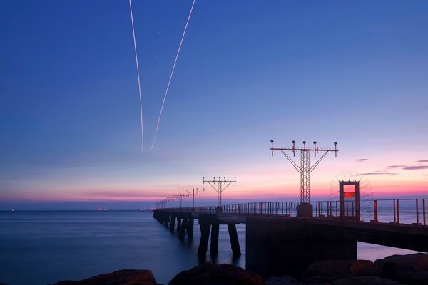 A bridge stretching into the distance and everything is purple