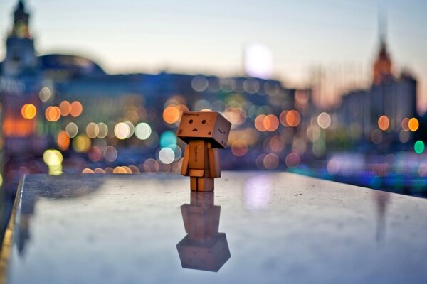 Romance - a figurine against the background of a blurred city