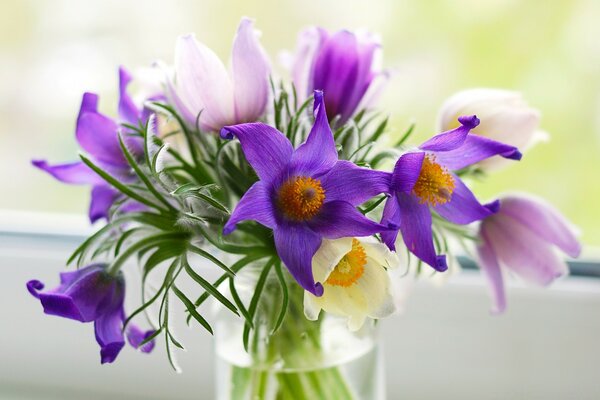 A bright bouquet of flowers in a glass vase