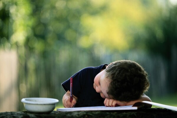 A child drawing outdoors