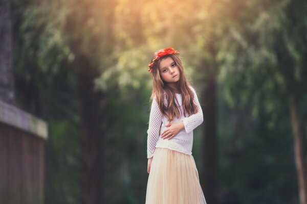 A girl in a red riding hood outdoors