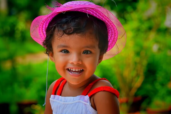 A beautiful child with a pink panama hat