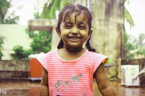 Little girl laughing in the rain