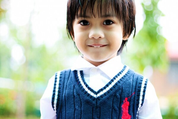 Portrait of a boy in a knitted vest