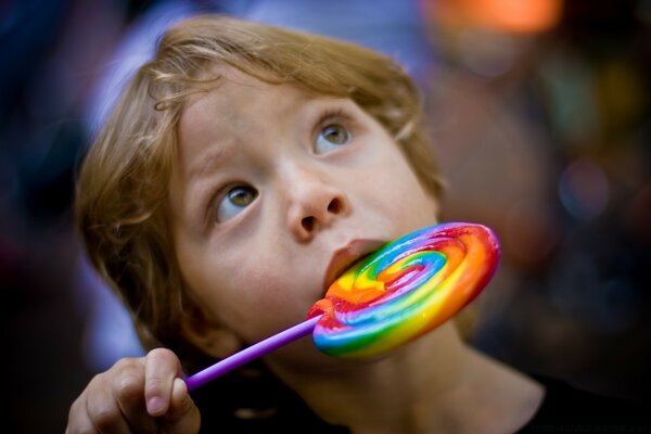 A small child eats a lollipop