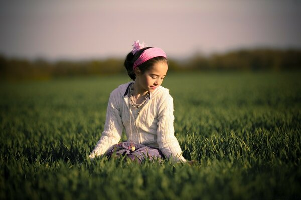 A girl on a green field. Spring