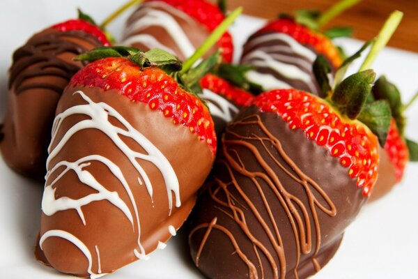 Chocolate-covered strawberries on a white plate