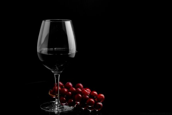 A handful of juicy cherries to a large glass of wine