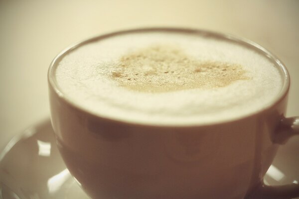 Cappuccino coffee with foam in the shape of a heart