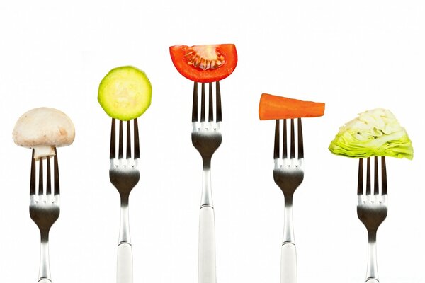 Vegetables on a fork on a white background