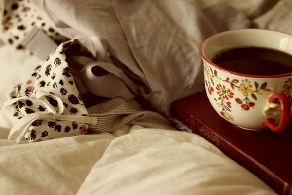 A cup of hot coffee in bed