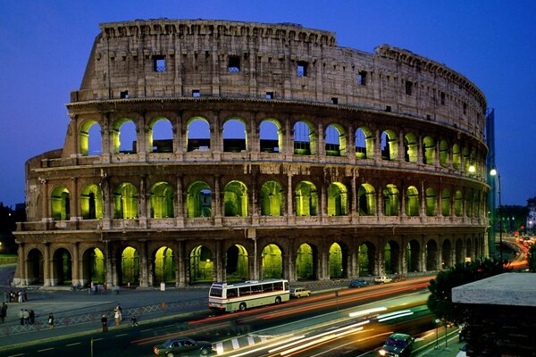 The ancient structure of the Colosseum with illumination