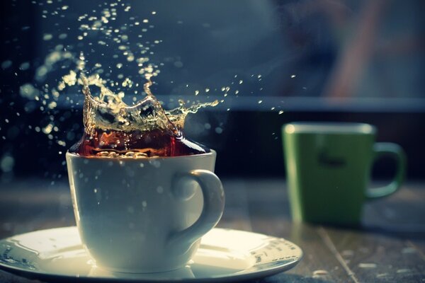 Coffee splashes from a white porcelain mug