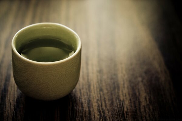 Still life from a cup of coffee on a dark table surface