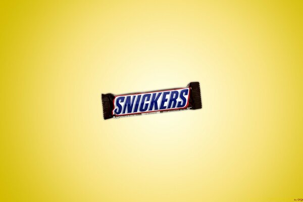 A snickers bar on a yellow background