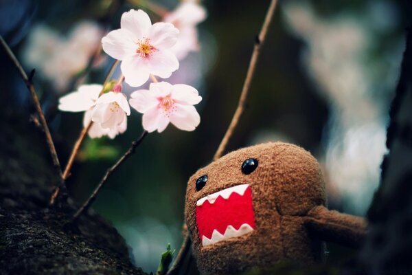 A plush monster screams at a non-protective flower