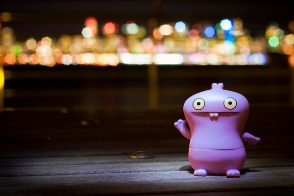 Toy on the background of city lights