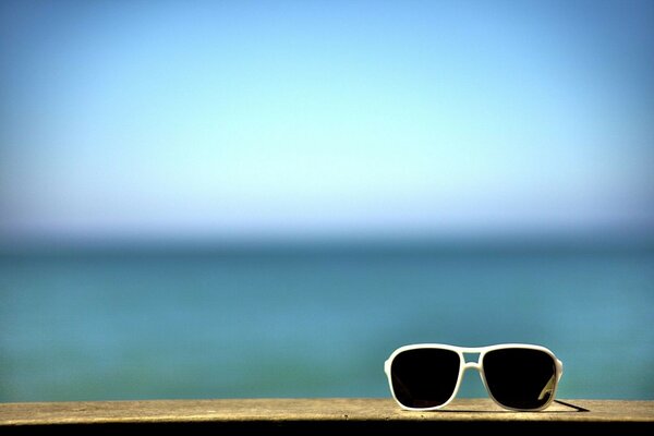 Sunglasses on the background of the sea