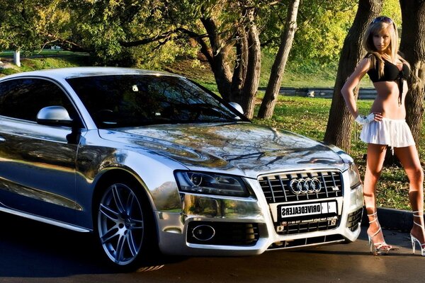 Audi car with a girl on the background of the forest