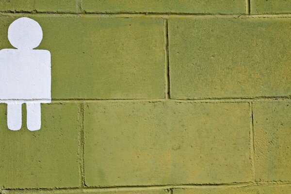 Silhouette on a green brick wall