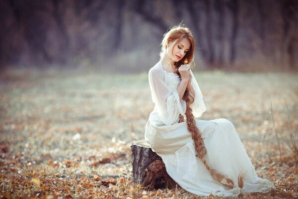 A girl in nature in autumn listens to fresh air