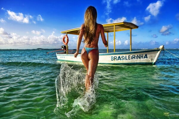 A girl in a swimsuit on a clear sea