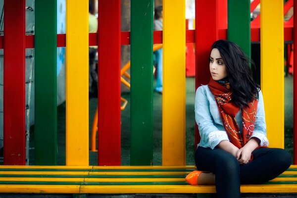 A woman near a colorful fence