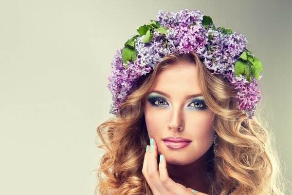 Beautiful girl with a wreath of lilac