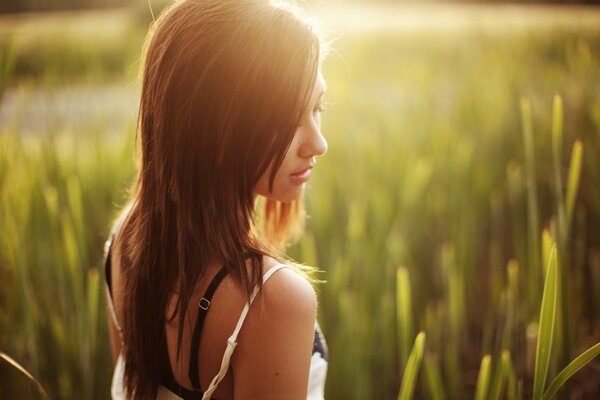 Photo of a beautiful girl in the glare of sunlight