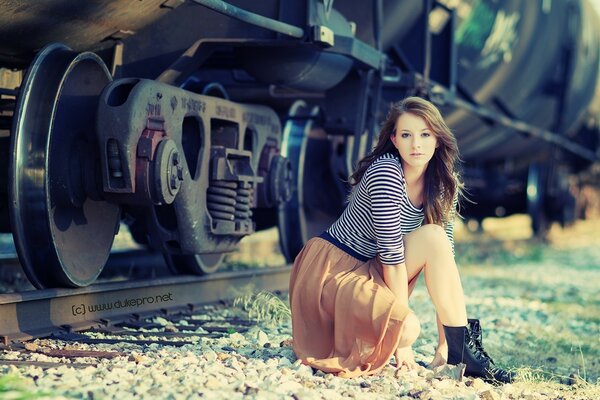 A girl on the background of an old steam locomotive