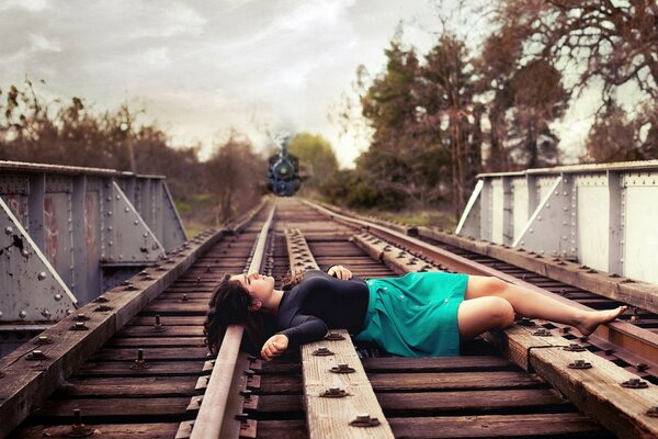 A girl on the rails of a railway train