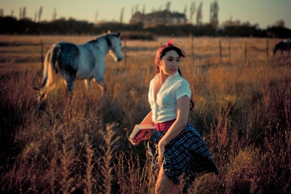 Girl outdoors at sunset with horses