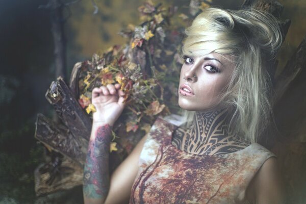 Tattooed fairy resting in a forest clearing