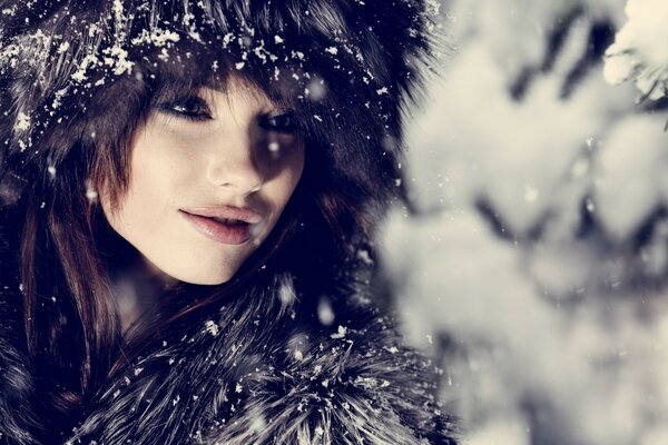 A girl in furs in winter in the forest