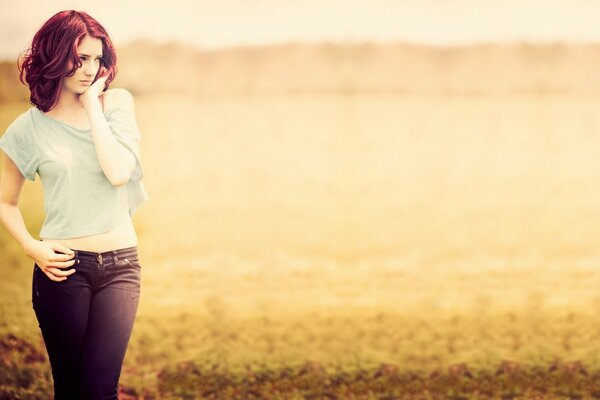 Photo of a beautiful girl at sunset in summer