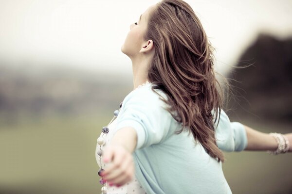 Photo of a young girl with outstretched arms