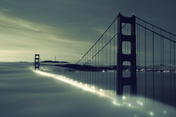 Suspension bridge over the water at sunset