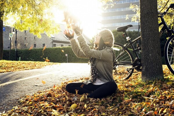 Autumn day. Girl with leaves