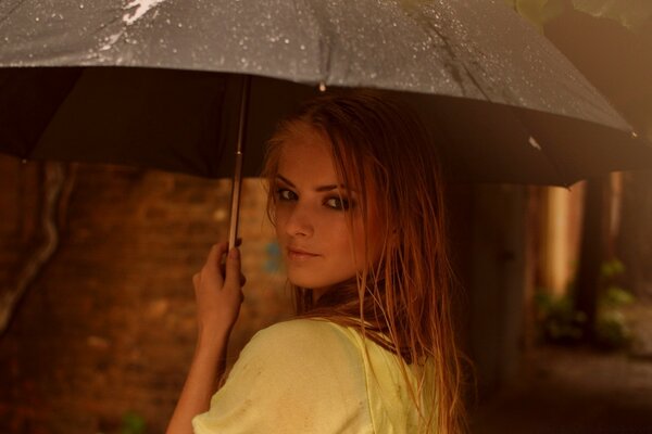 Romantic portrait of a girl under an umbrella summer vacation on the beach