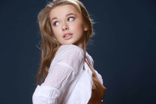 Portrait of a cute girl on a dark blue background